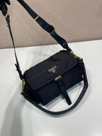Prada crossbody bag, dark navy, angled view with front flap and gold hardware