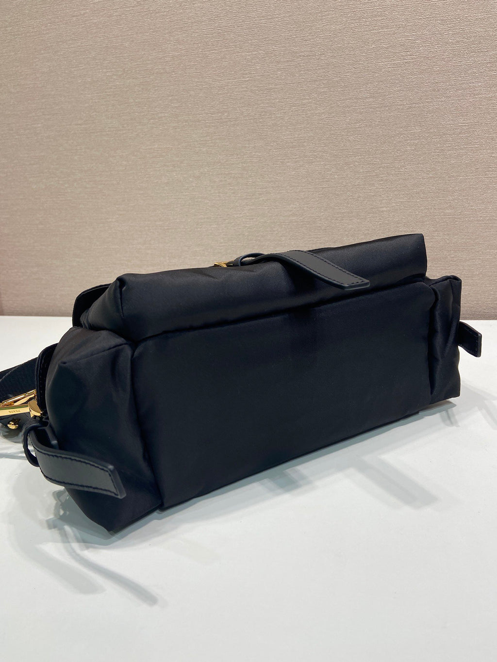 Prada crossbody bag, dark navy, back view with smooth panel and side pocket