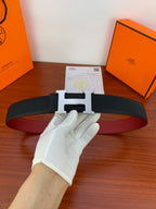 Leather belt with dark textured strap and silver-toned H buckle detail