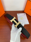 Leather belt with black textured finish and gold H buckle, shown close-up.