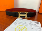 Leather belt with black textured strap and gold-tone H buckle, with red lining