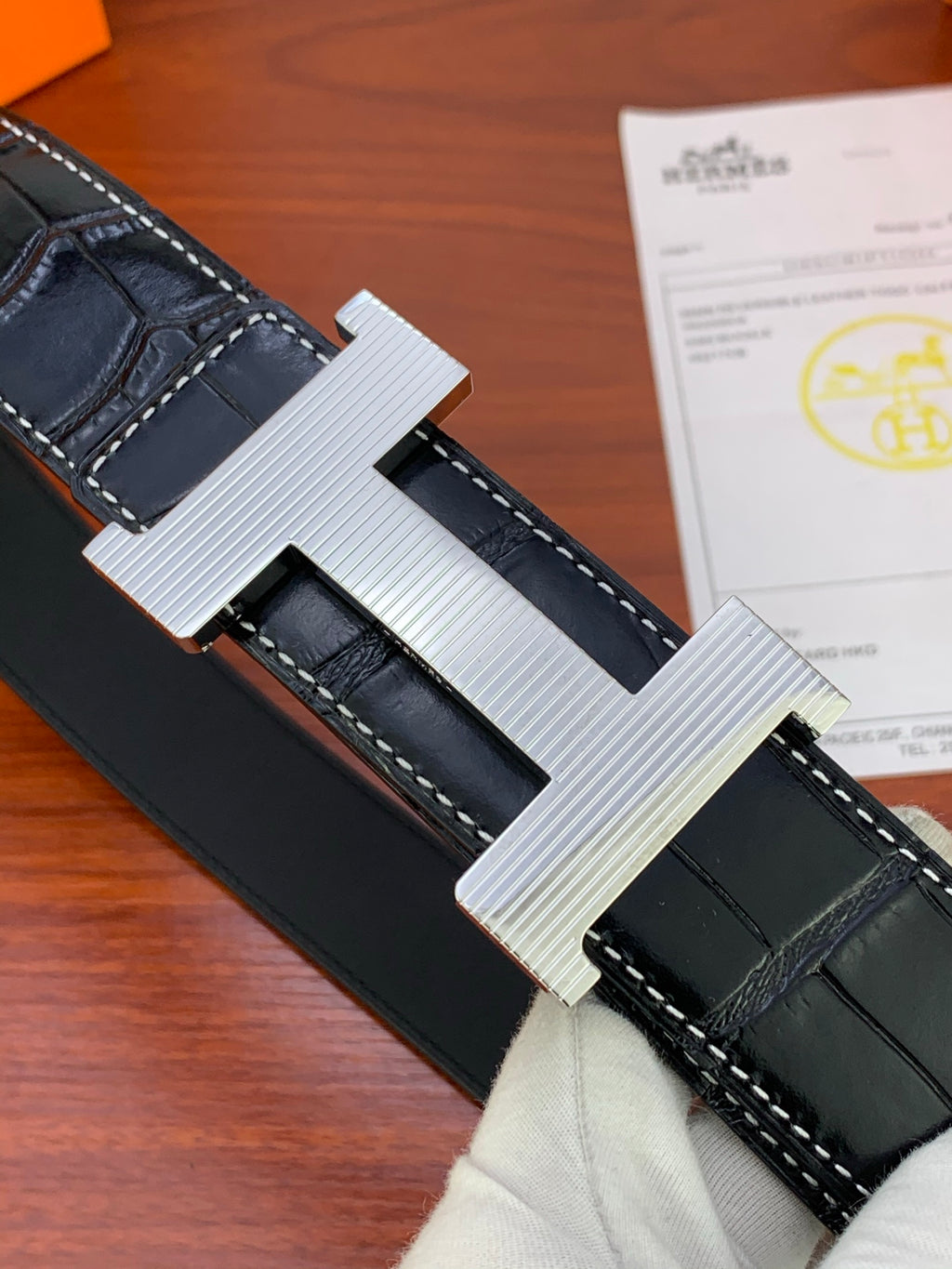 Croc-pattern leather belt buckle with brushed metal finish and stitched strap.
