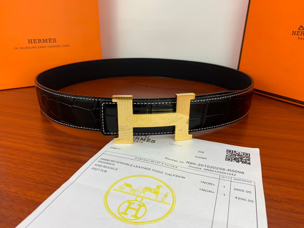 Croc-embossed leather belt with dark strap and gold-tone buckle.