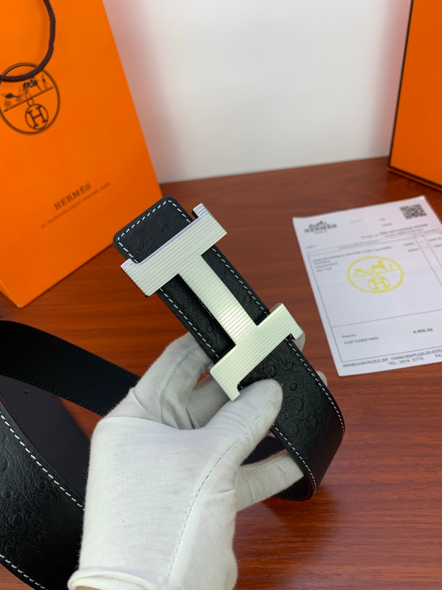 Hermes dark leather belt with light silver H buckle and contrast stitching