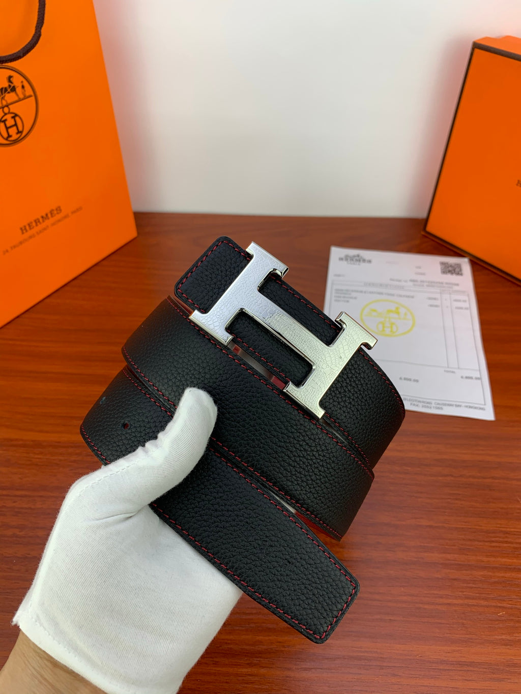 Black leather belt with gold H buckle and black keeper tab