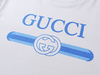 White T-shirt chest graphic with blue Gucci lettering and logo emblem