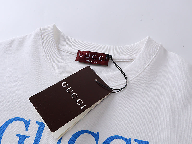 White T-shirt neckline with Gucci tag and attached brown hangtag