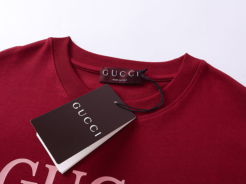 Burgundy Gucci T-shirt neckline with tag and pink logo graphic