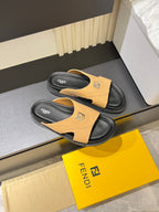 Tan Fendi slide sandals with black thick sole and strap logo, pair view.