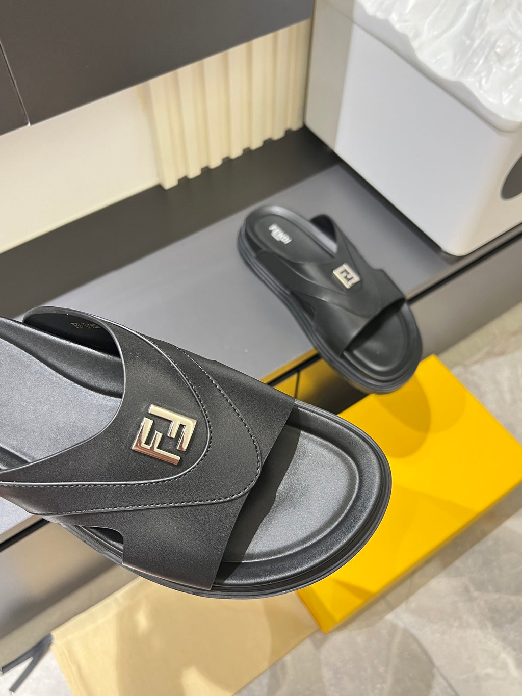 Fendi black slide sandal close-up of strap with FF logo and seam stitching