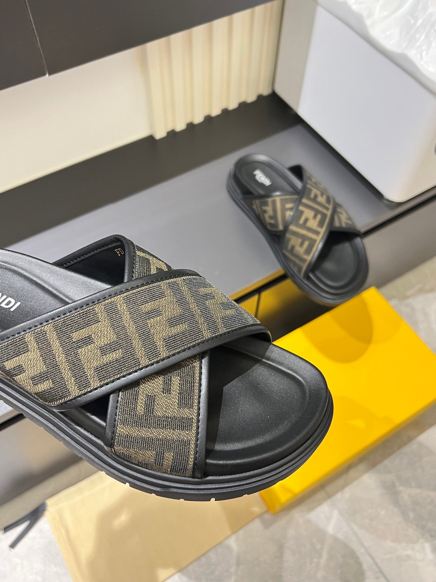 Fendi FF monogram slide sandals close-up with black footbed and sole