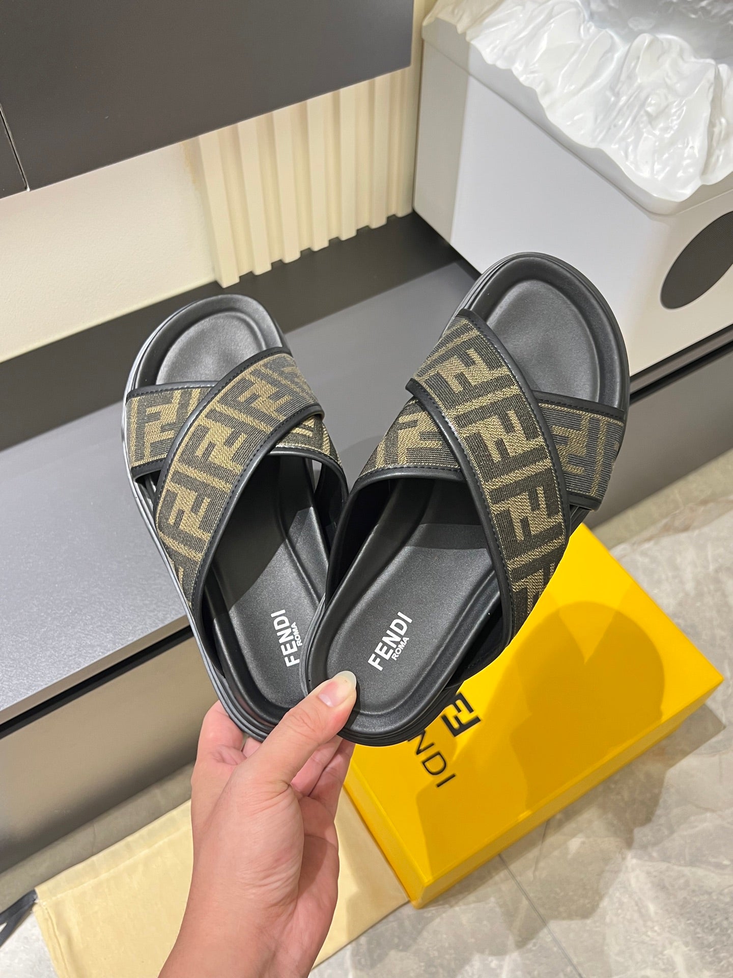 Fendi FF monogram slide sandals shown from side view with black straps