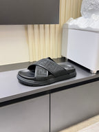 Gray Fendi slide sandal with textured strap and cushioned footbed.