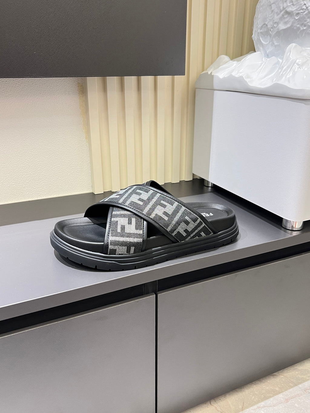 Fendi FF slide sandal with wide crisscross straps and thick rubber sole