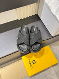 Gray Fendi slide sandals with wide cross straps and textured logo footbed.