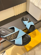 Fendi slide sandals with light blue straps and FF monogram panel on dark footbeds