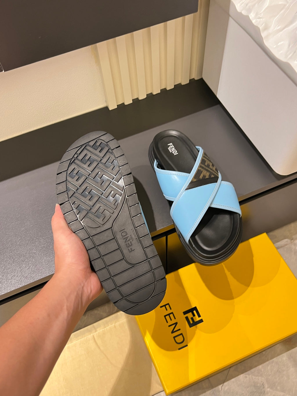 Fendi slide sandal with dark gray tread outsole and light blue straps