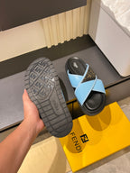 Fendi slide sandal with dark gray tread outsole and light blue straps