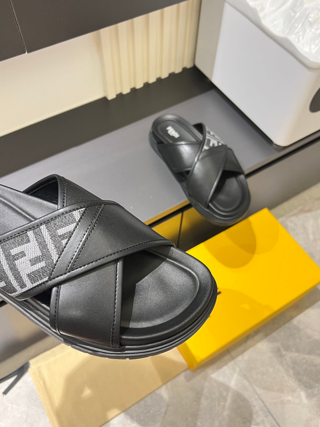 Black Fendi slide sandals close-up, wide strap with FF logo band