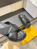 Black Fendi slide sandals showing textured cross strap and thick contoured sole