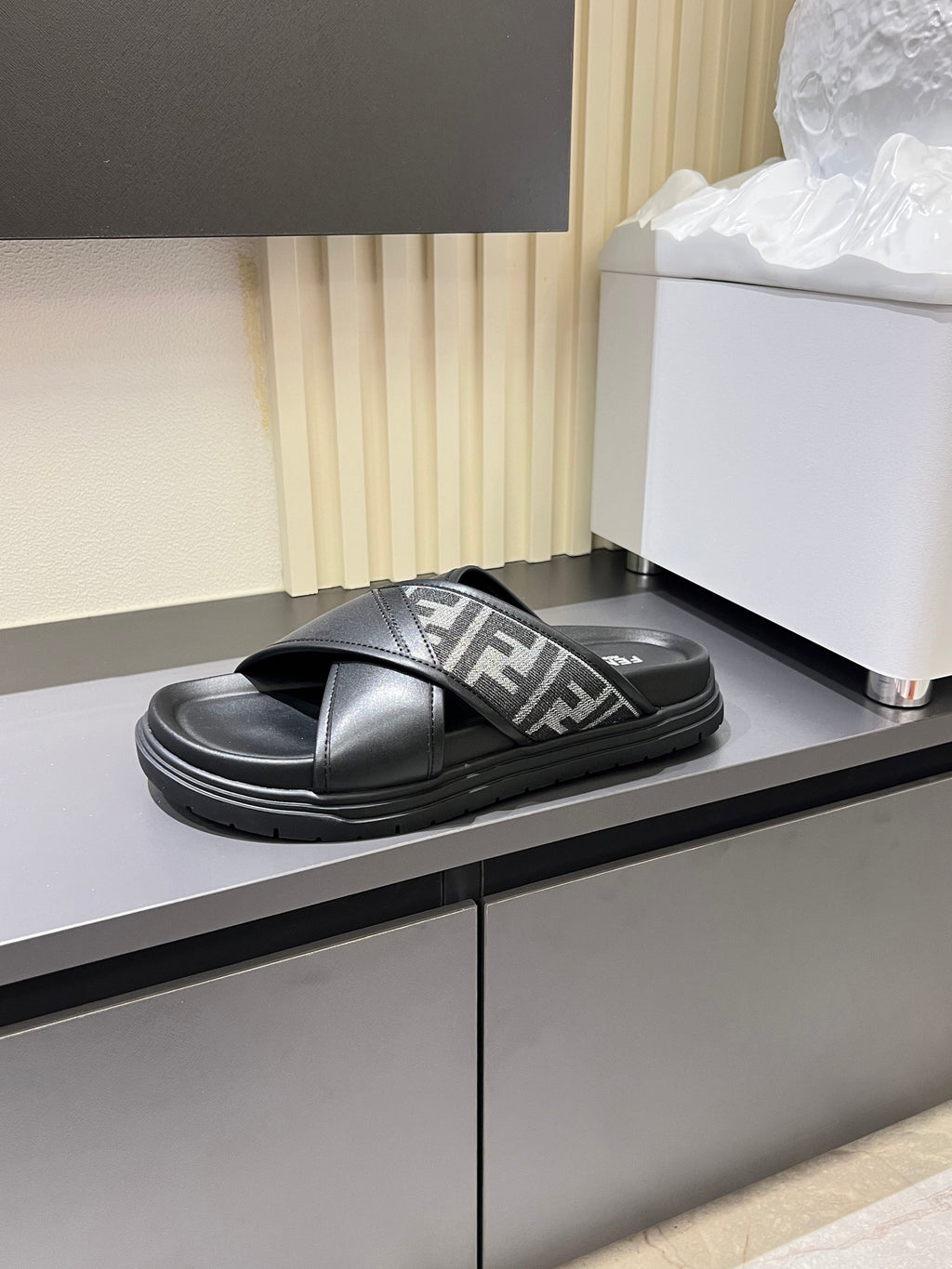 Black Fendi slide sandal with crossed strap and FF logo panel