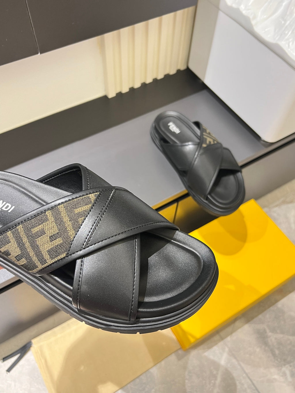 Fendi black slide sandals with FF logo strap detail and wide crossover band