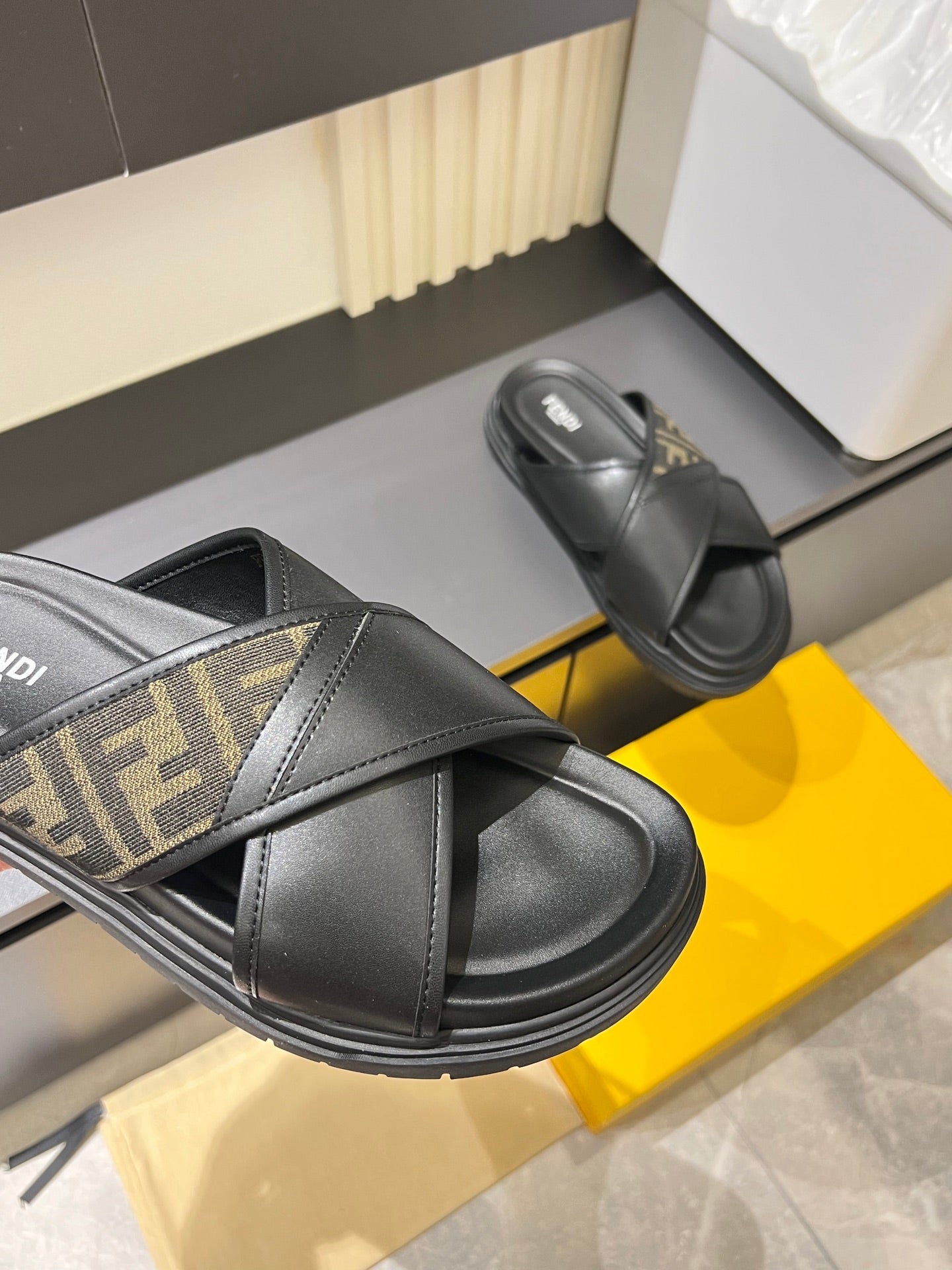 Fendi black slide sandals with FF logo strap detail and wide crossover band
