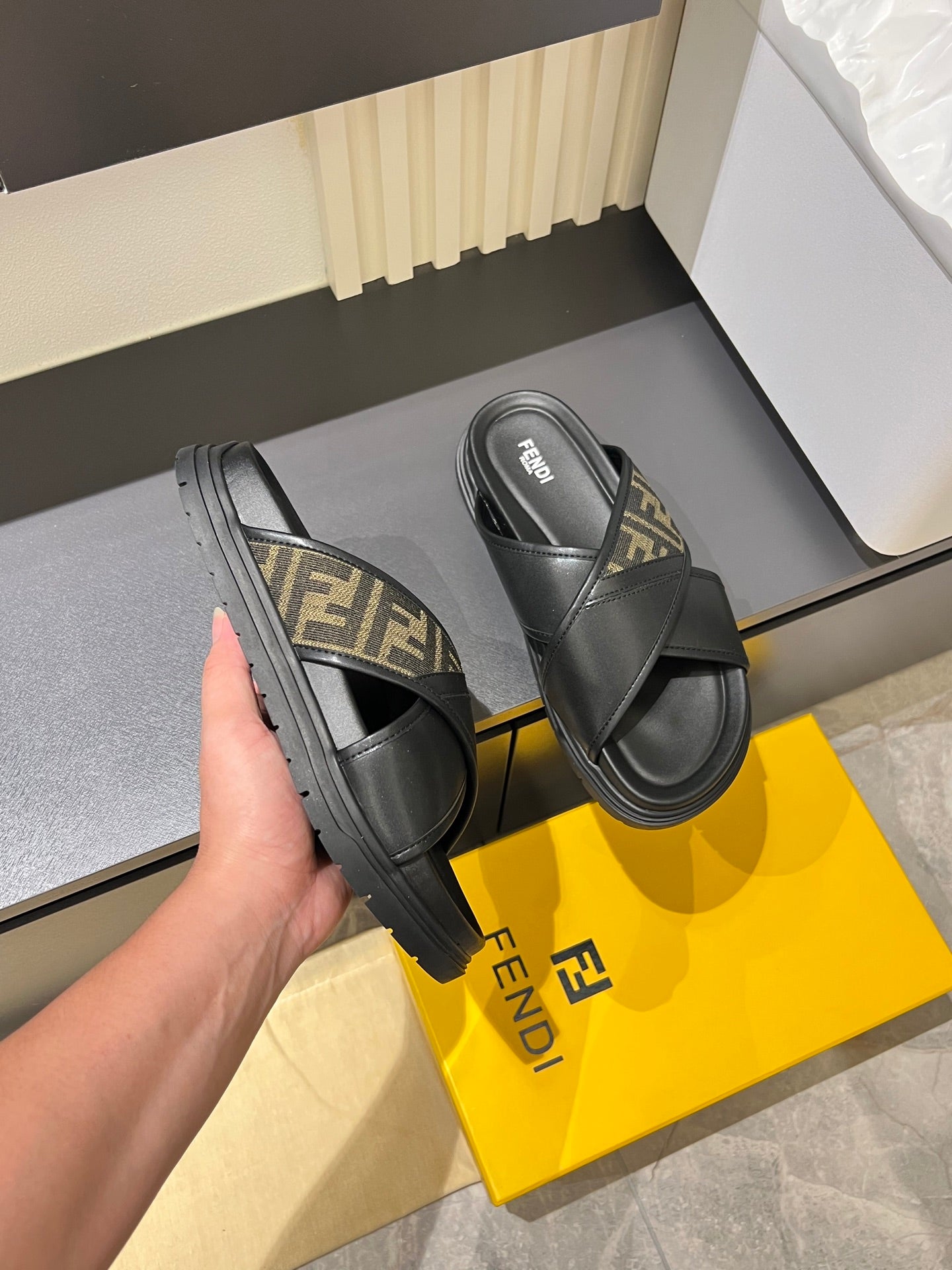Fendi black slide sandals with FF-pattern straps and thick rubber sole