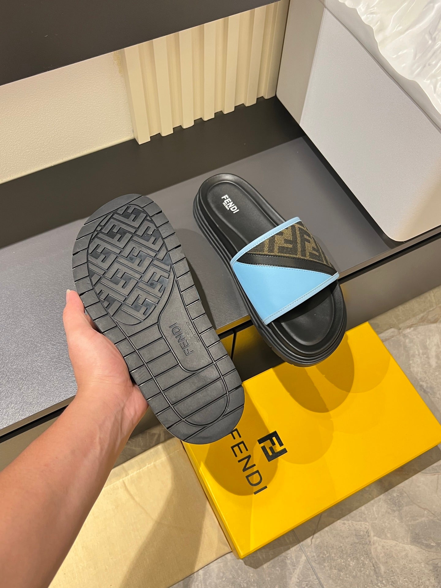 Fendi slide sandals outsole: textured black tread with light blue FF strap