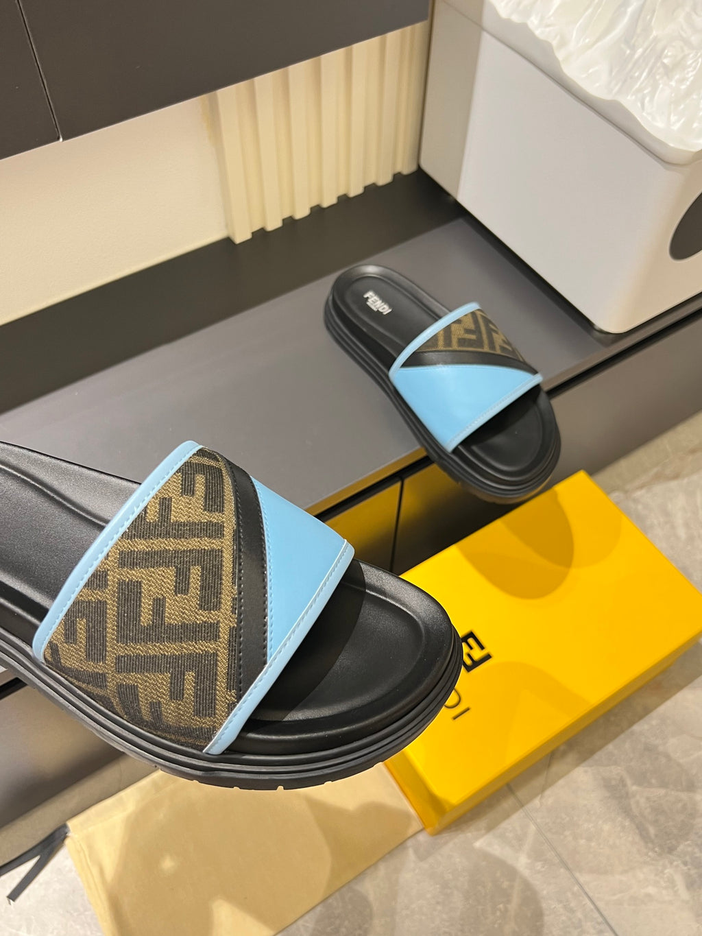 Fendi slide sandals: blue FF strap on black sole