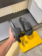 Fendi dark gray slide sandals with textured strap and thick rubber platform sole