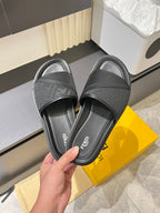 Fendi dark gray slide sandals showing smooth strap and branded footbed