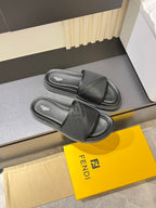 Fendi dark gray slide sandals with crossover strap and stacked rubber sole edges