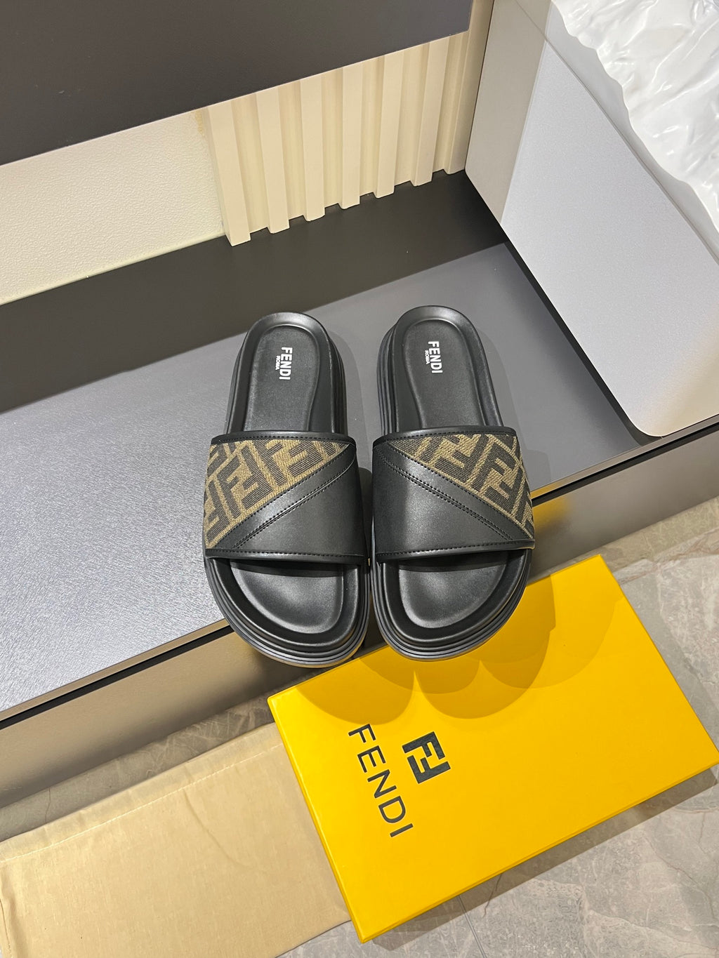Fendi slide sandals with black leather straps and FF monogram detail