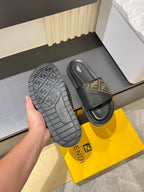 Fendi slide sandals with outsole tread and FF monogram strap on black slides