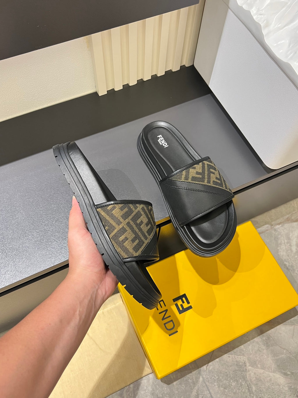 Fendi slide sandals side view, FF monogram strap on black sole