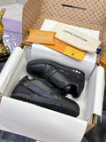 Black low-top sneakers with textured panels, lace-up front, and rubber sole detail