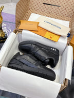 Black low-top sneakers with textured panels, lace-up front, and rubber sole detail