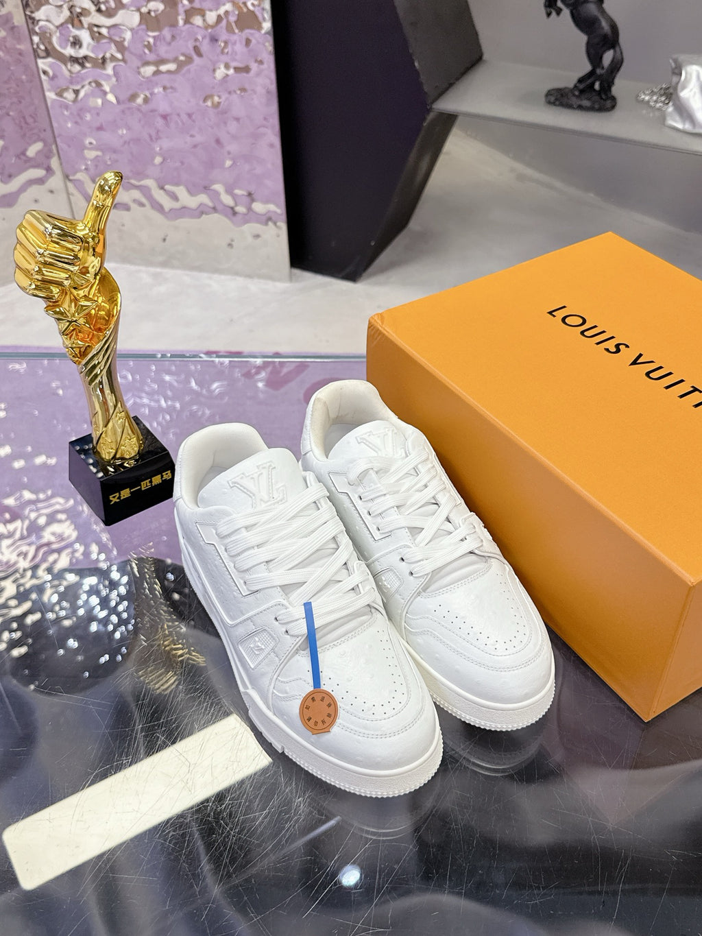 Louis Vuitton white lace-up sneakers, textured uppers and tan logo patch on tongue