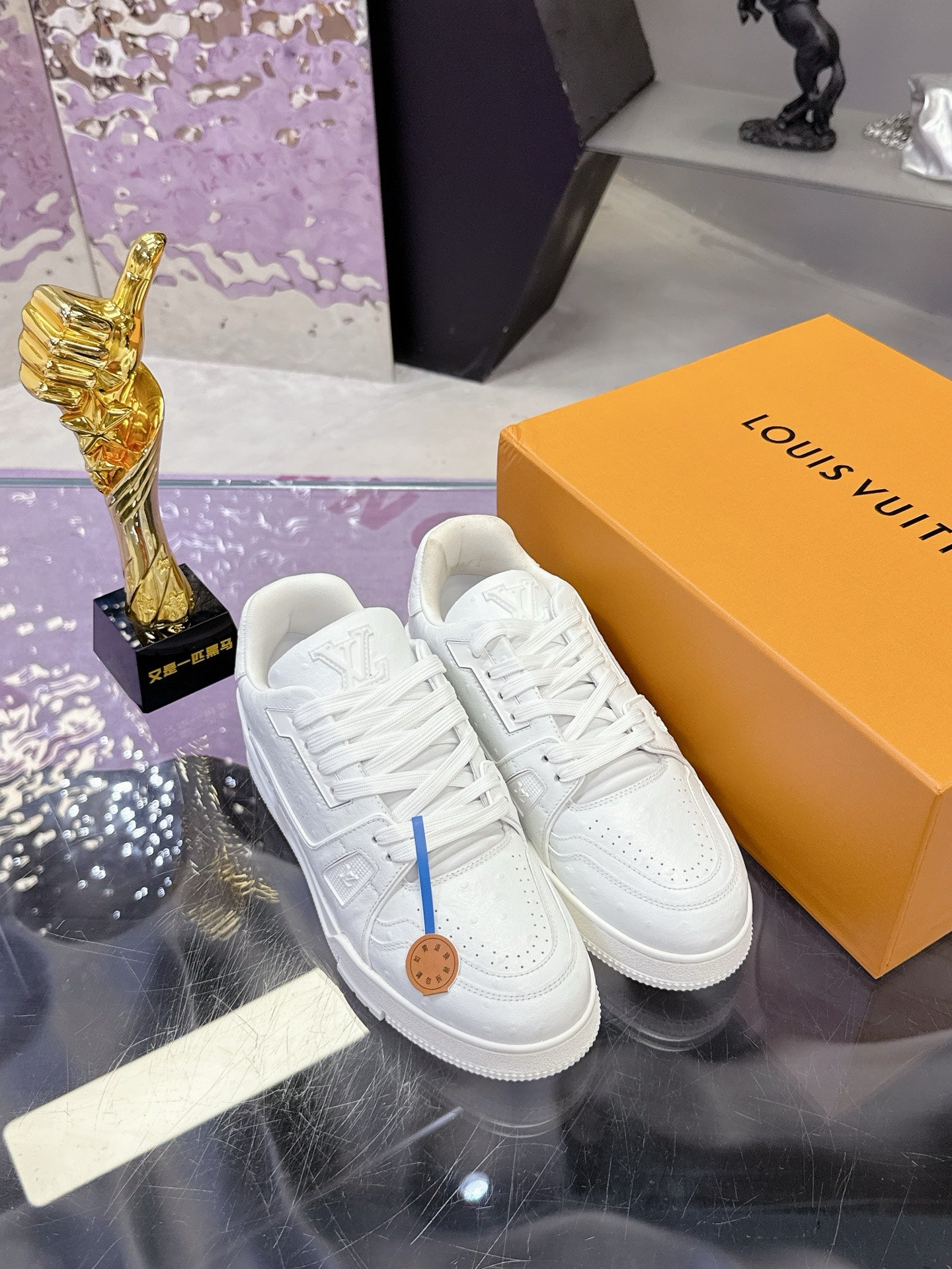 Louis Vuitton white lace-up sneakers, textured uppers and tan logo patch on tongue