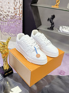 Louis Vuitton white lace-up sneakers on a box, blue side stripe, tan logo patch