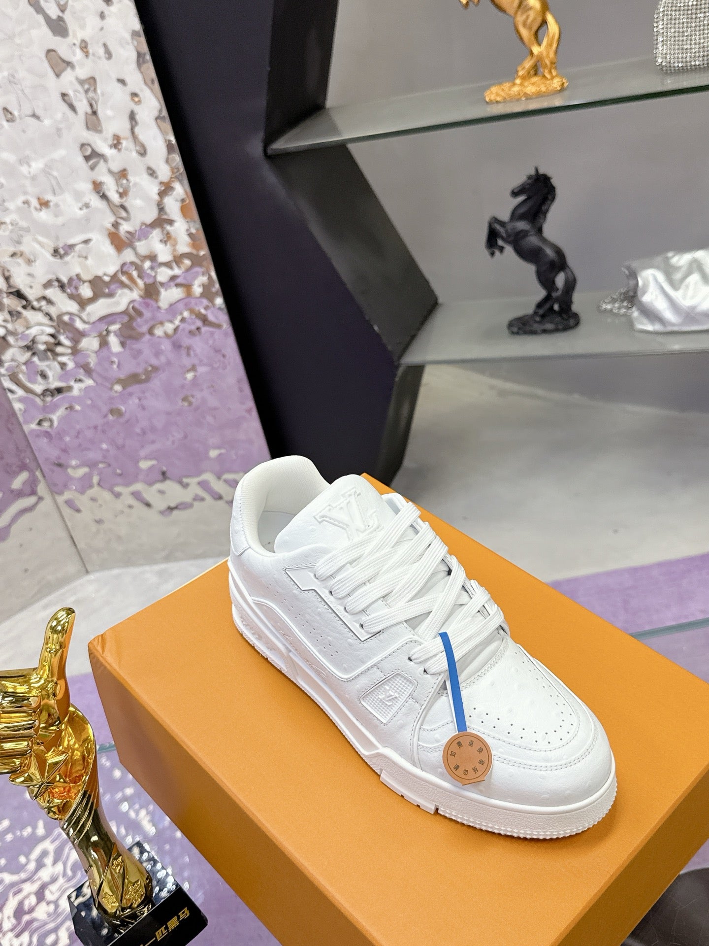 Louis Vuitton white low-top sneakers with blue side stripe and lace-up design