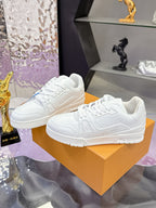 Louis Vuitton white low-top sneakers with lace-up front and chunky sole on display box