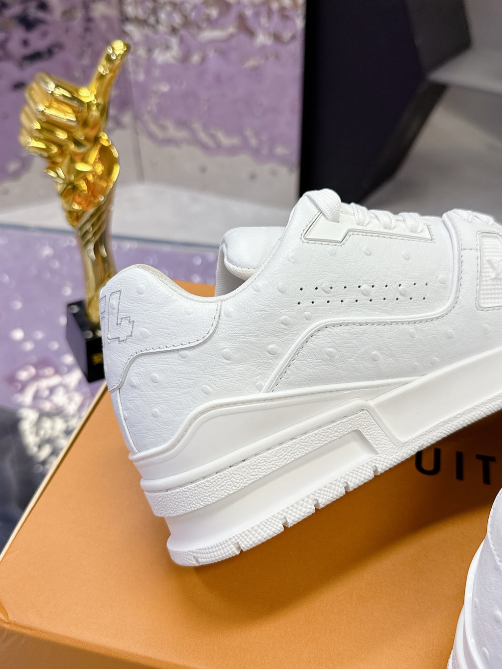 Louis Vuitton white low-top sneaker with side panel stitching and textured rubber sole