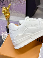 Louis Vuitton white low-top sneaker with side panel stitching and textured rubber sole