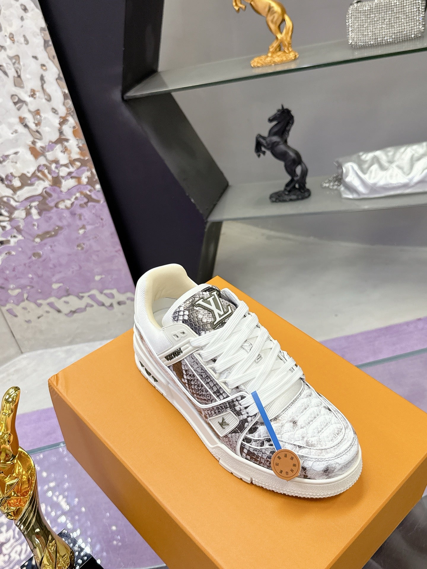 White Louis Vuitton lace-up sneakers with black printed panel and tan logo tag