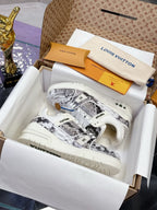 White Louis Vuitton ladies sneakers with patterned side panels and white laces