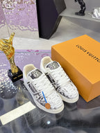 White Louis Vuitton lace-up sneakers with black logo panel and patterned toe cap