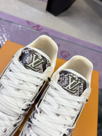 Close-up of white Louis Vuitton sneakers with black monogram logo on the side