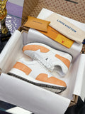 Pair of white and orange low-top sneakers with lace-up front and rubber sole